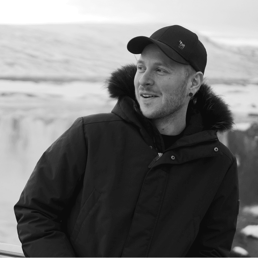 Einar Logi Óskarsson in front of a waterfall in winter